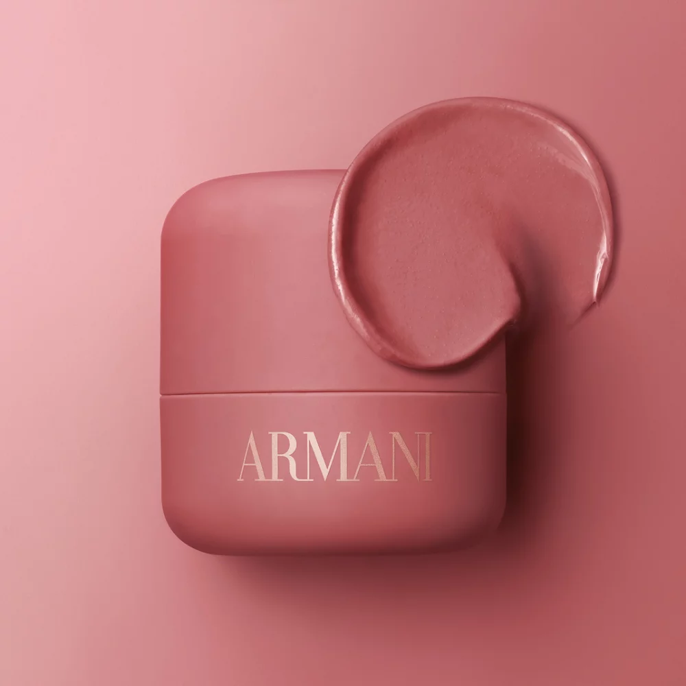 Armani Dolci Blush compact in dusty rose, showcased on a matching pink background with soft sculptural shapes.