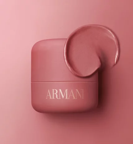 Armani Dolci Blush compact in dusty rose, showcased on a matching pink background with soft sculptural shapes.