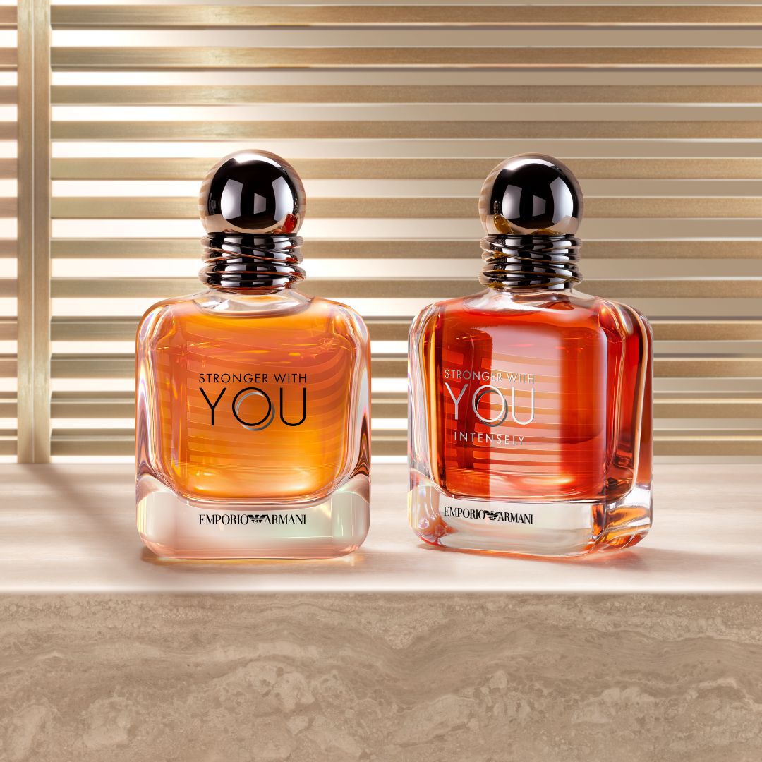 3 bottles of men's cologne on a blue colored background