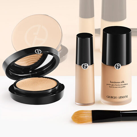 Three product bottles of Armani beauty Luminous Silk Foundation, Concealer, and Powder