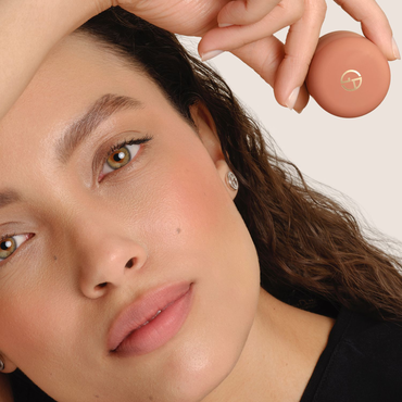 Model showcasing Armani Beauty Dolci Blush in a nude shade, an on-the-go cream-to-powder blush for a natural healthy glow.