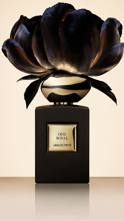 Bottle of Armani/Prive Oud Royal against beige background with an opulent black flower.