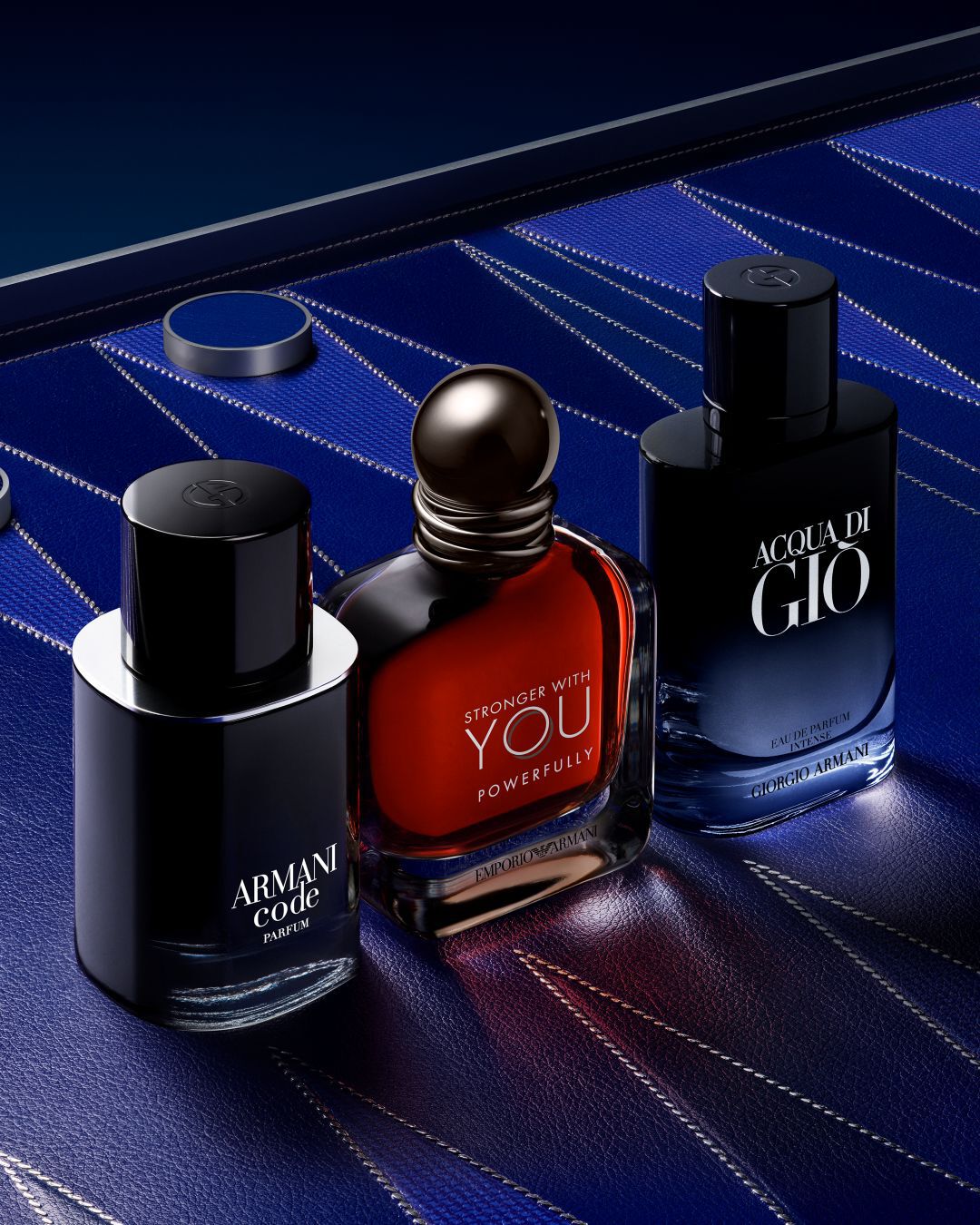 3 bottles of men's cologne on a blue colored background