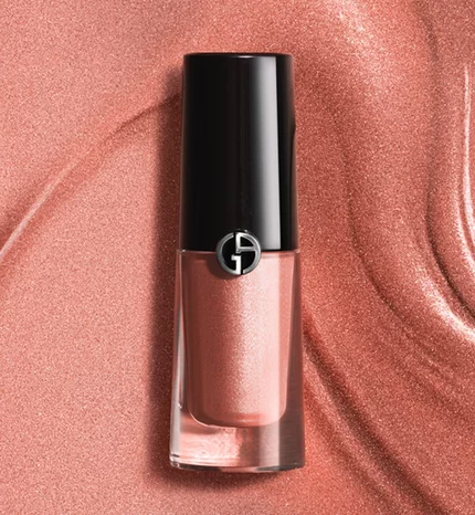Giorgio Armani Eye Tint liquid eyeshadow in a shimmery rose-gold shade, displayed on a silky copper-toned texture background.