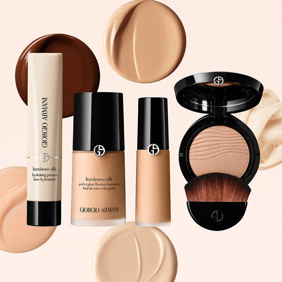 A collection of Giorgio Armani makeup products on beige background with 5 foundation circles.