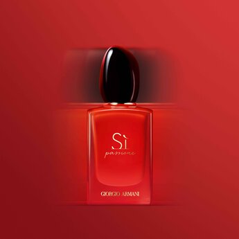 Bottle of Si Passione Eau De Parfum Intense on red background.