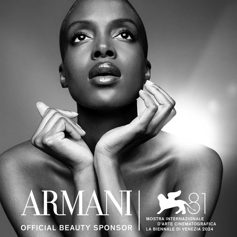 A model gazes upwards with text that says "Armani Beauty Sponsor"