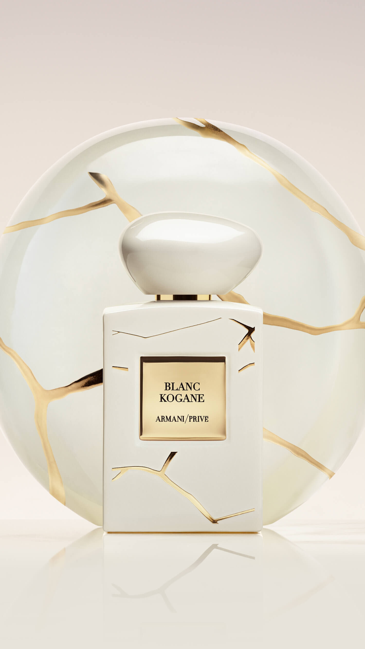 Bottle of Armani/Prive Blanc Kogane against a light beige background.